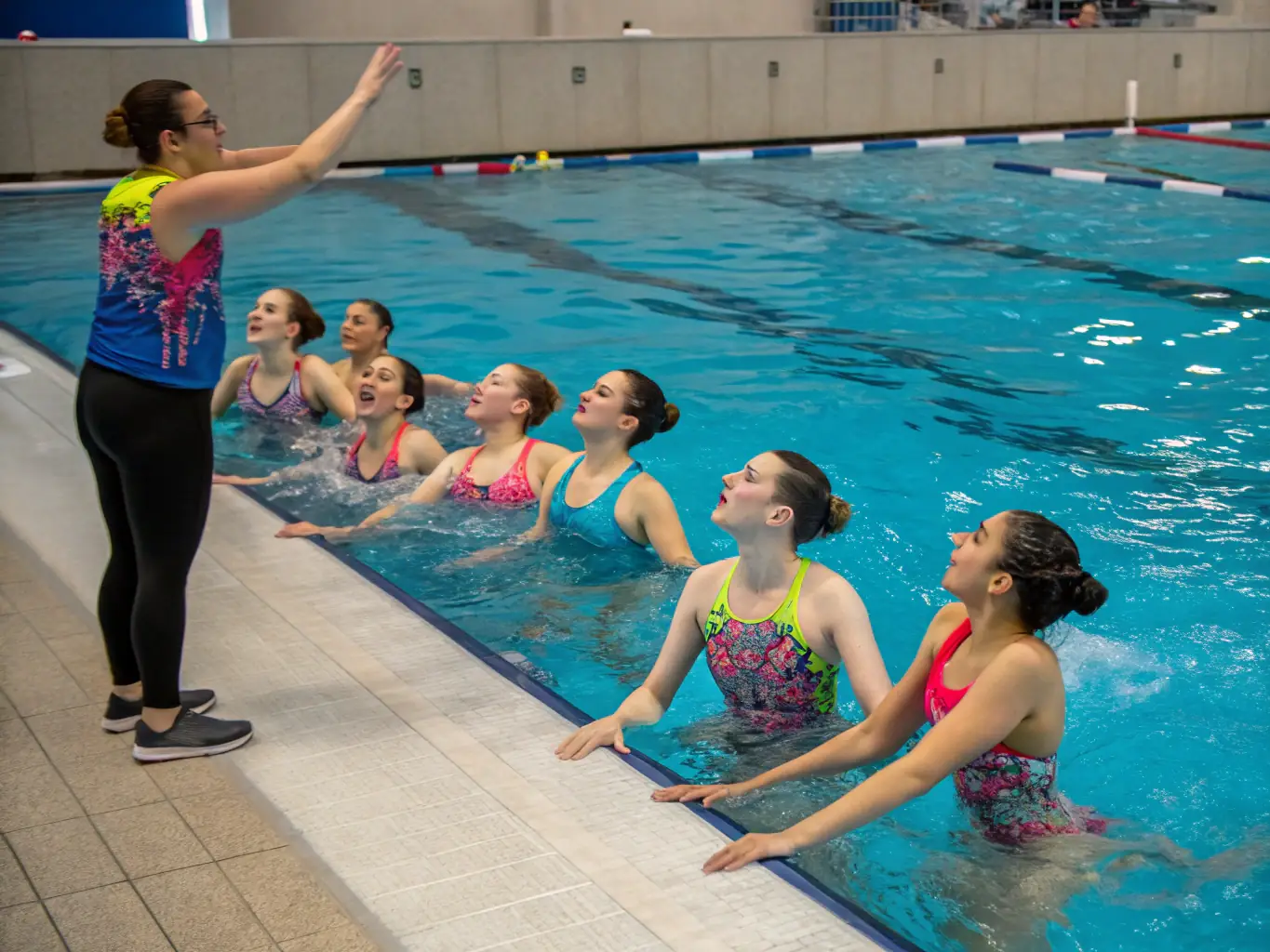 An inspiring photo of students swimming laps in a pool, emphasizing the benefits of swimming for overall fitness and well-being.